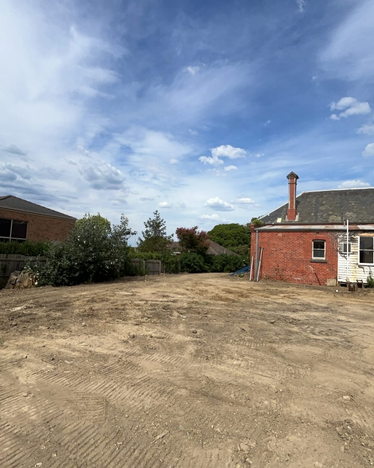 Cleared and levelled block next to a red brick house