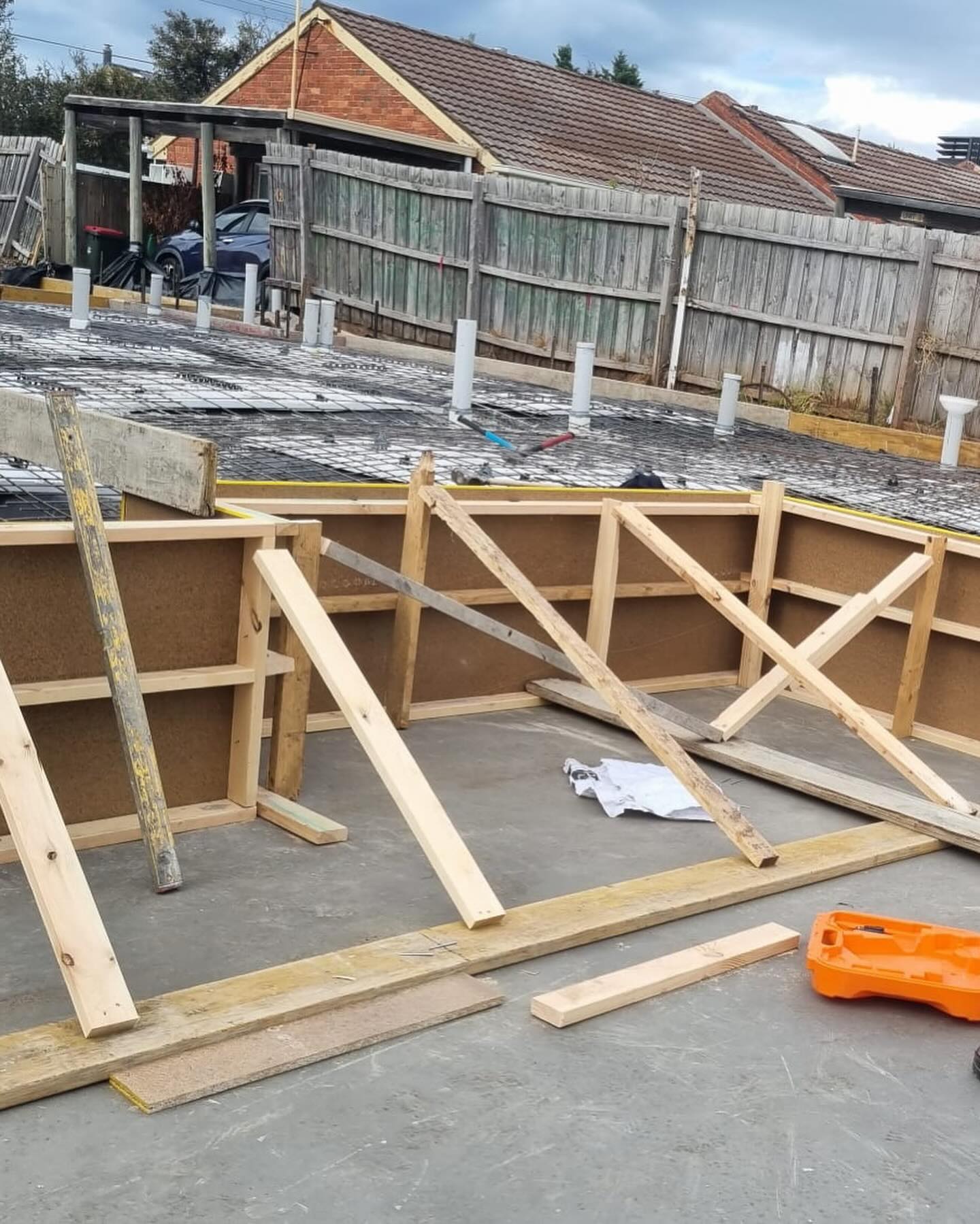 Braced timber formwork set up on a concrete slab