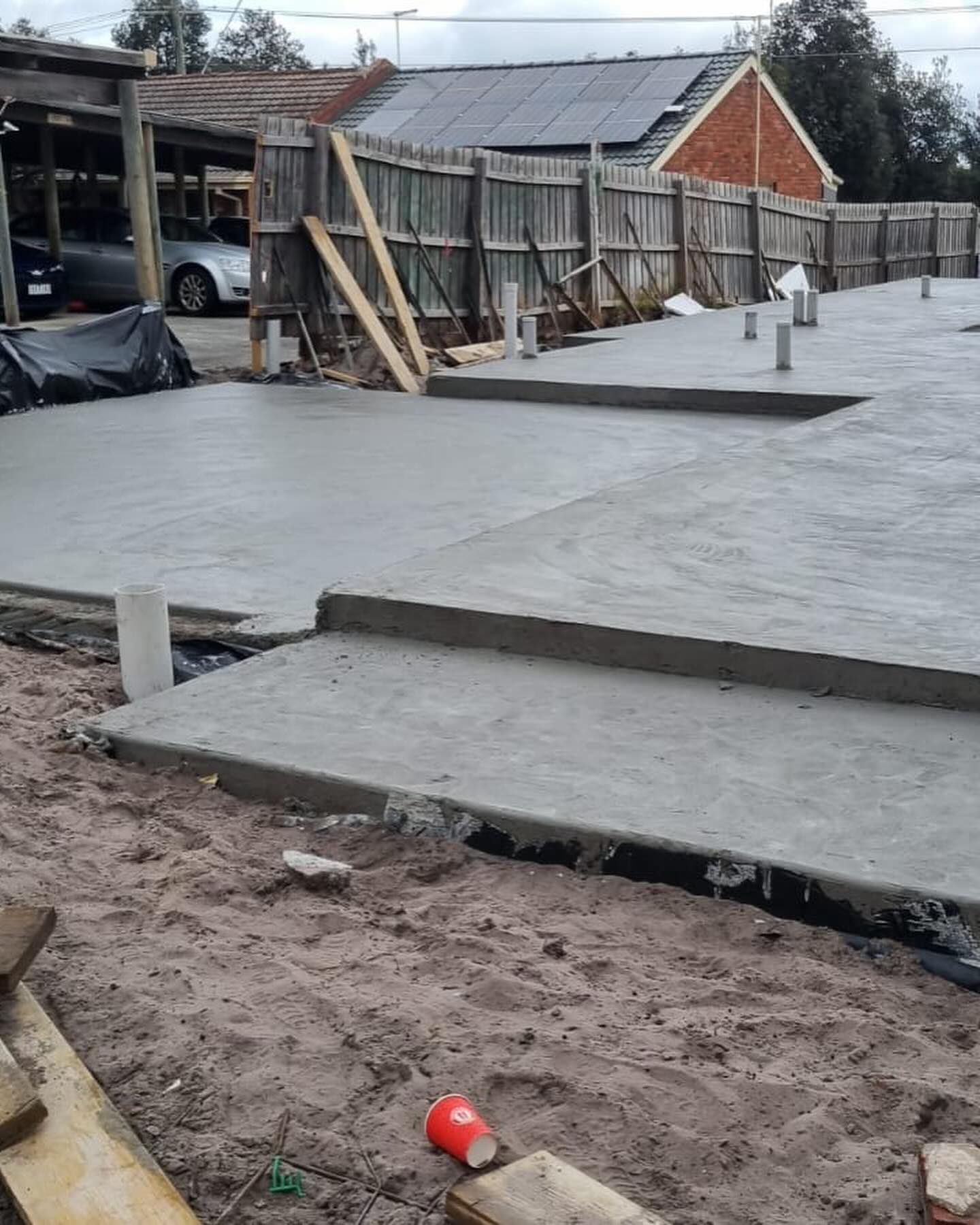 Freshly poured concrete slab with a stepped edge on a house site